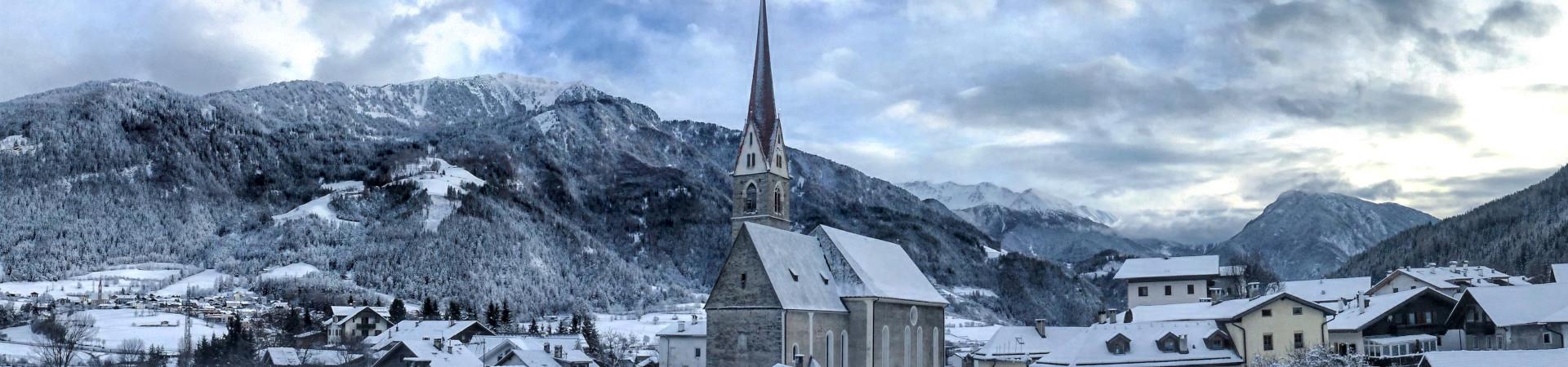 Verschneites+Dorf+mit+Fokus+auf+den+Kirchturm